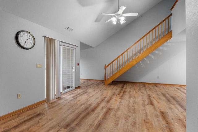 unfurnished living room with stairs, wood finished floors, visible vents, and baseboards