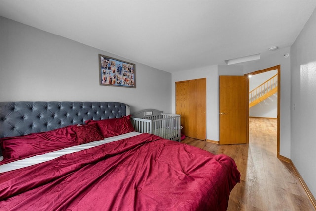 bedroom with baseboards and wood finished floors