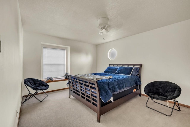 bedroom featuring carpet floors, ceiling fan, a textured ceiling, and baseboards