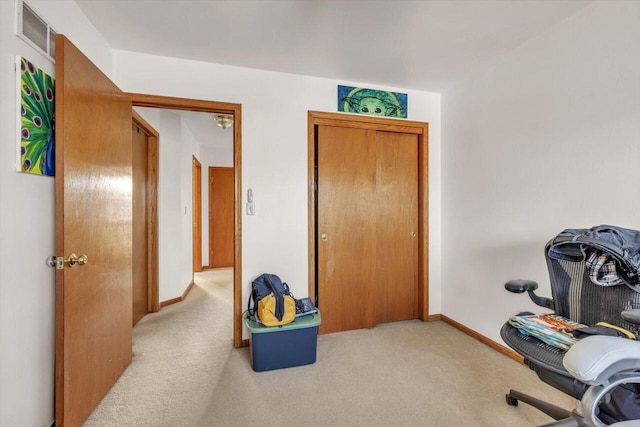 office space with carpet floors, visible vents, and baseboards