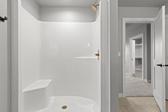 full bath with a shower stall and tile patterned floors