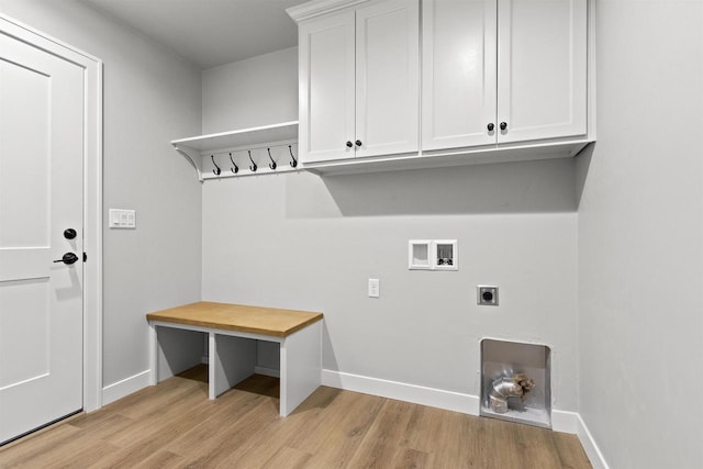 laundry area with light wood-type flooring, cabinet space, hookup for a washing machine, and hookup for an electric dryer