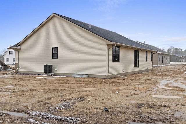 view of side of home with central AC