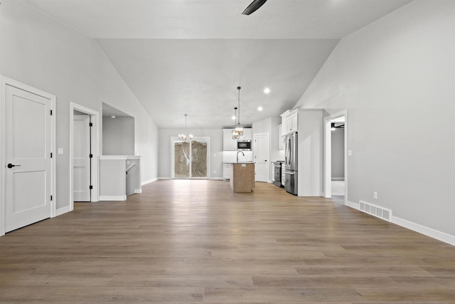 unfurnished living room featuring light wood-type flooring, baseboards, and visible vents