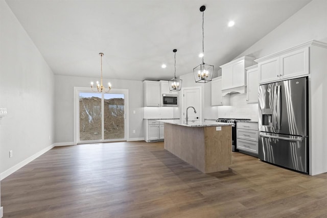 kitchen with dark wood-style flooring, vaulted ceiling, stainless steel appliances, white cabinetry, and a notable chandelier