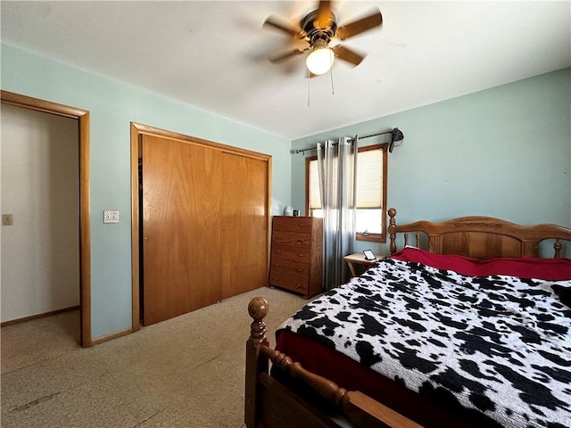 bedroom featuring a ceiling fan, carpet, a closet, and baseboards