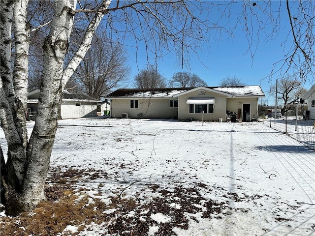 snow covered house featuring a garage