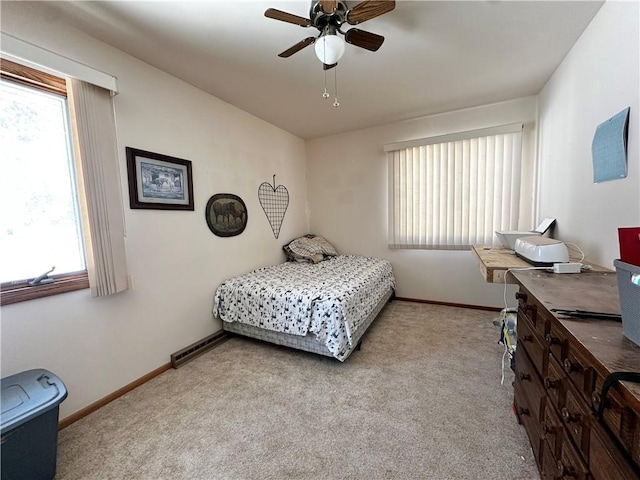 bedroom featuring carpet, multiple windows, and baseboards