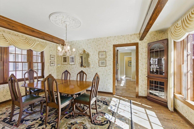 dining room featuring baseboards, beamed ceiling, an inviting chandelier, and wallpapered walls