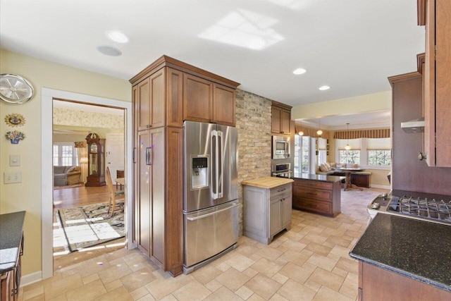 kitchen featuring appliances with stainless steel finishes, a wealth of natural light, recessed lighting, and extractor fan