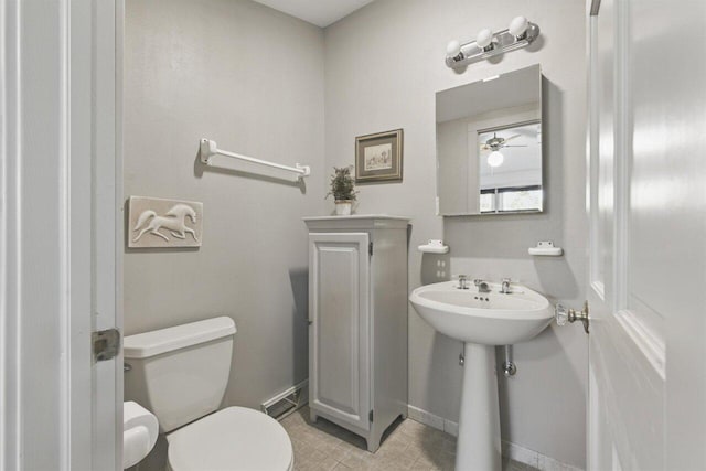 bathroom featuring toilet and baseboards