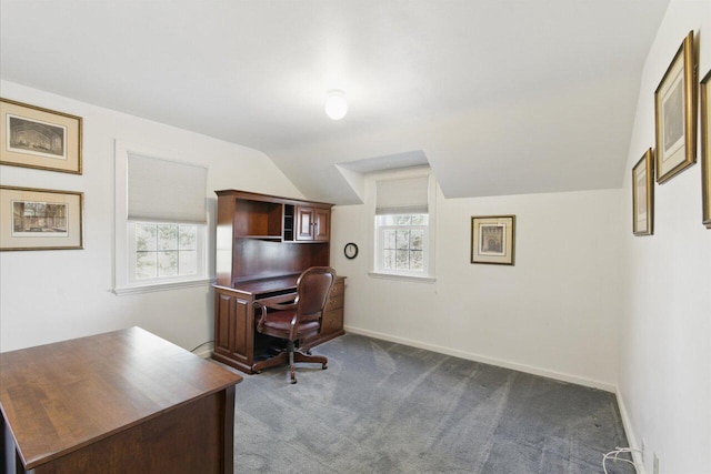 office featuring baseboards, dark carpet, vaulted ceiling, and a wealth of natural light