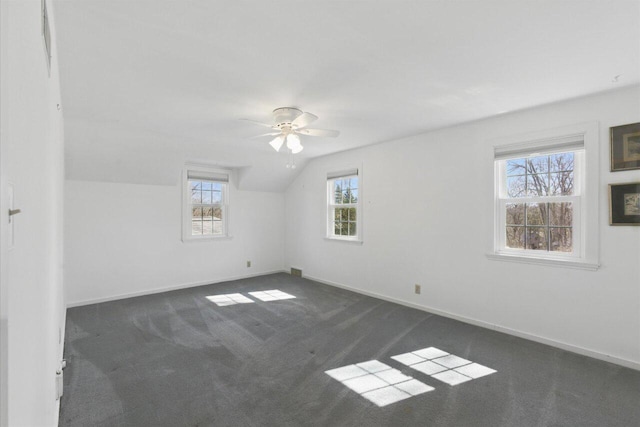 bonus room with lofted ceiling, baseboards, dark carpet, and a ceiling fan