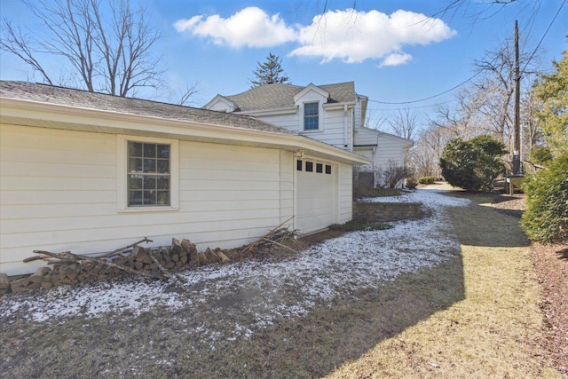 view of side of home featuring a shingled roof