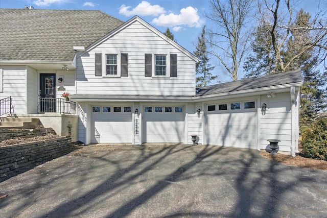 garage with aphalt driveway