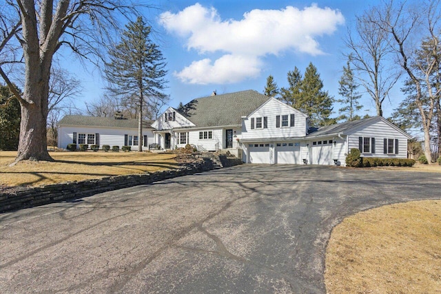 view of front of house with a front lawn and aphalt driveway