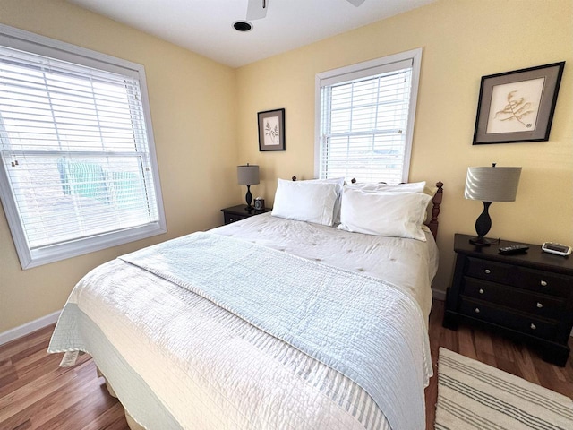 bedroom with baseboards and wood finished floors