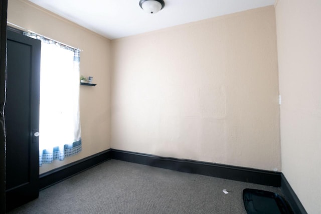 spare room with carpet and baseboards