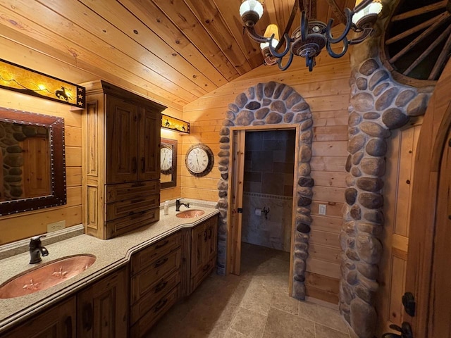 full bath with a sink, wooden walls, wooden ceiling, and vaulted ceiling