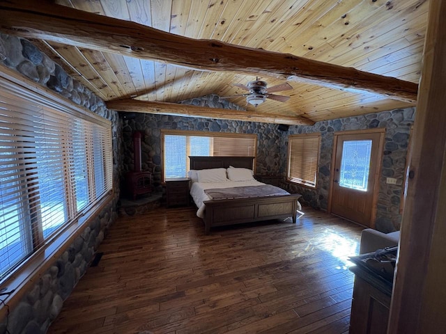 unfurnished bedroom with a wood stove, wood ceiling, vaulted ceiling with beams, and hardwood / wood-style flooring