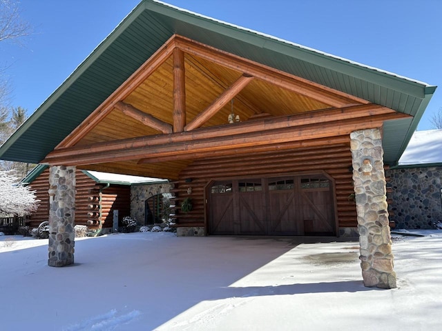 view of front of home featuring a garage and log exterior