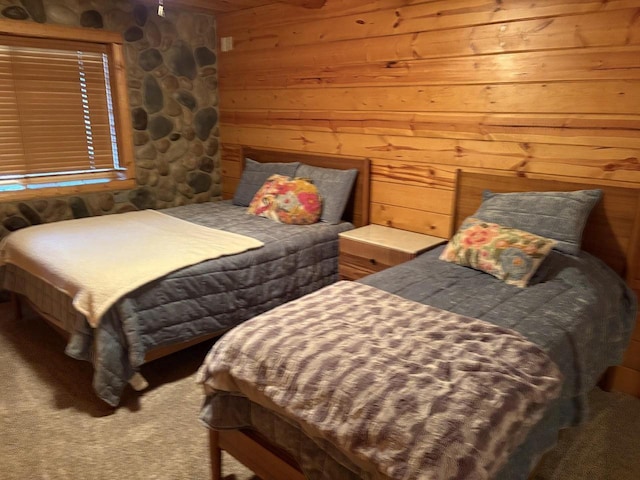 bedroom with wood walls and carpet floors