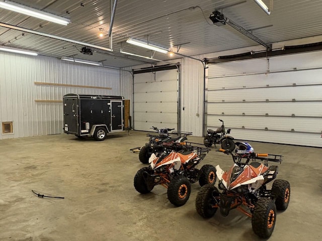 garage featuring metal wall and a garage door opener