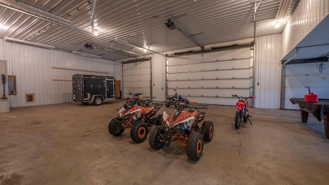 garage with metal wall and a garage door opener