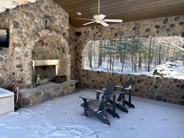 view of patio / terrace with an outdoor stone fireplace and ceiling fan