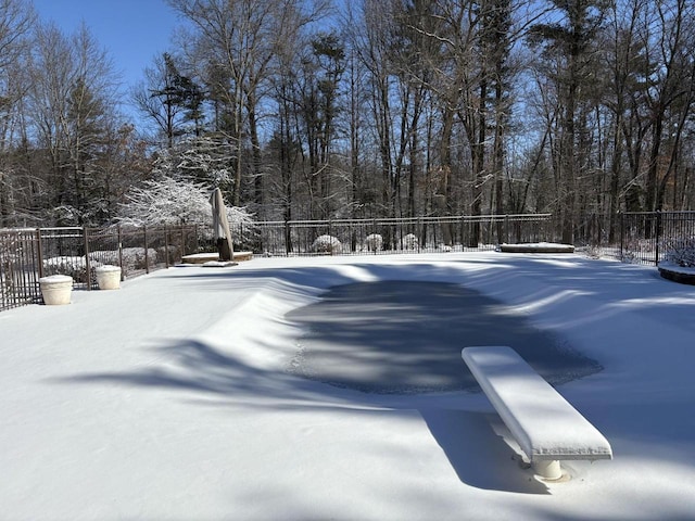 snowy yard featuring fence