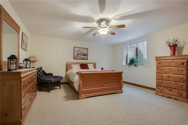 bedroom featuring a ceiling fan, light colored carpet, and baseboards