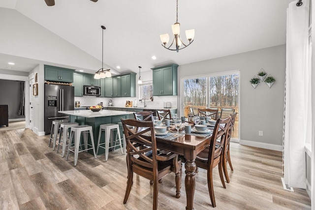 dining area with visible vents, baseboards, light wood-type flooring, high vaulted ceiling, and recessed lighting