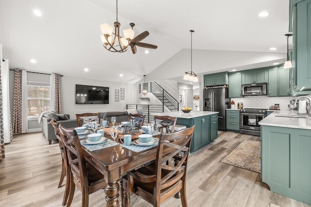 dining space with lofted ceiling, light wood finished floors, stairway, and recessed lighting