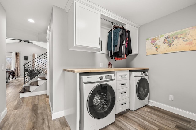 laundry area featuring recessed lighting, cabinet space, wood finished floors, independent washer and dryer, and baseboards