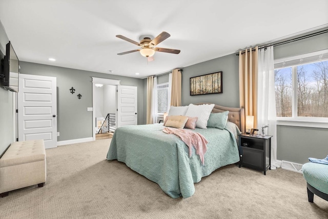 bedroom with light carpet, ceiling fan, baseboards, and recessed lighting