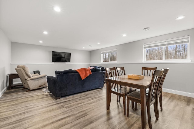 dining room with light wood finished floors, baseboards, and recessed lighting