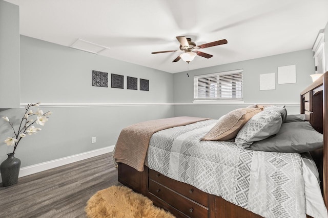 bedroom with a ceiling fan, wood finished floors, attic access, and baseboards