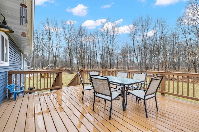 wooden deck featuring outdoor dining area