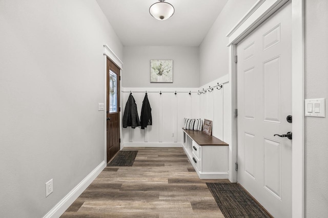 mudroom with dark wood-type flooring and baseboards