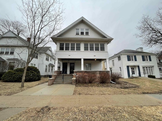 view of front of home featuring a porch and brick siding