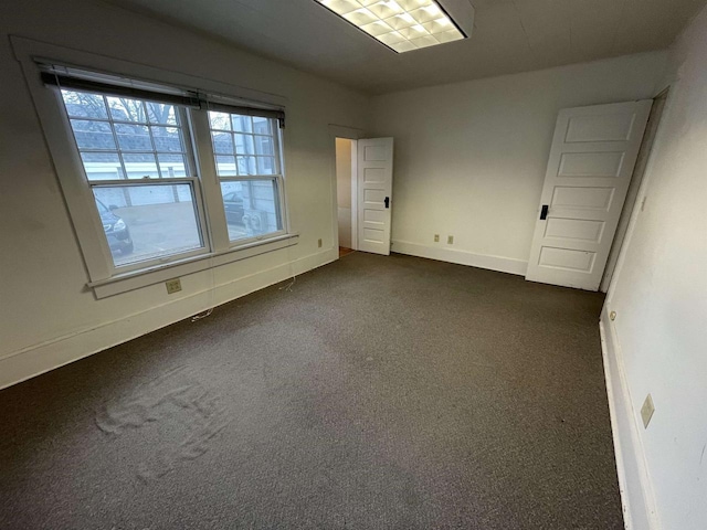 spare room featuring baseboards