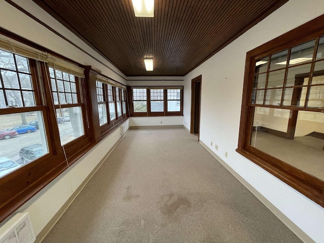 unfurnished sunroom with wooden ceiling and visible vents