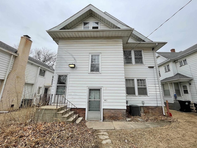 back of property featuring central AC