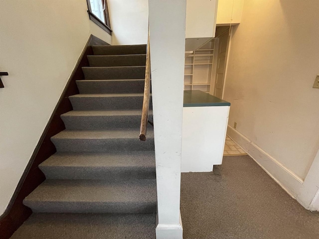 staircase with carpet and baseboards