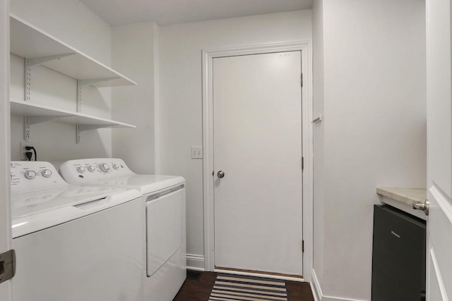 laundry room featuring laundry area, baseboards, washer and clothes dryer, and dark wood-style flooring