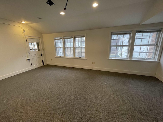 empty room with vaulted ceiling, recessed lighting, dark carpet, and baseboards