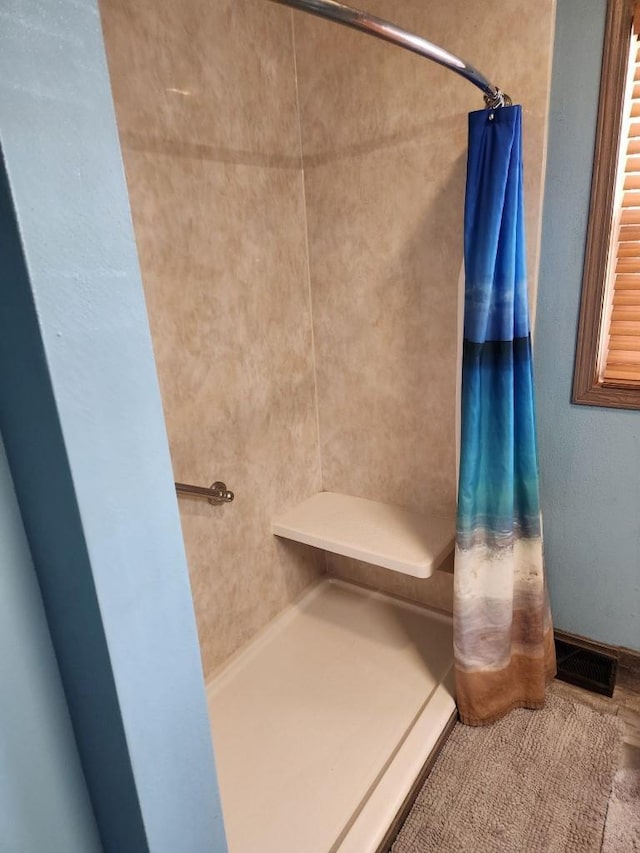 bathroom featuring visible vents and a shower with curtain