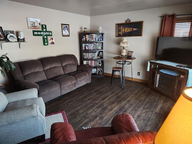 living room with baseboards and wood finished floors