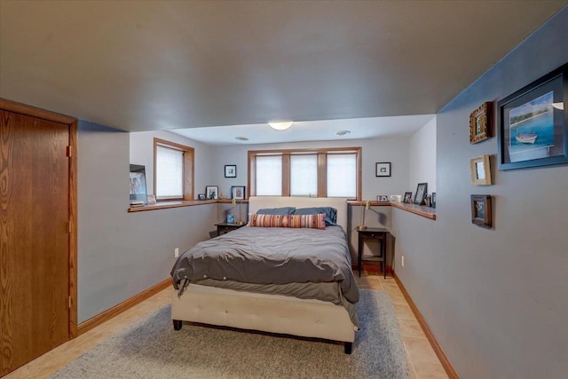 bedroom featuring baseboards and light tile patterned flooring