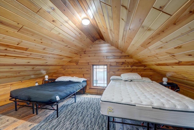 bedroom with vaulted ceiling, wooden ceiling, and wood walls